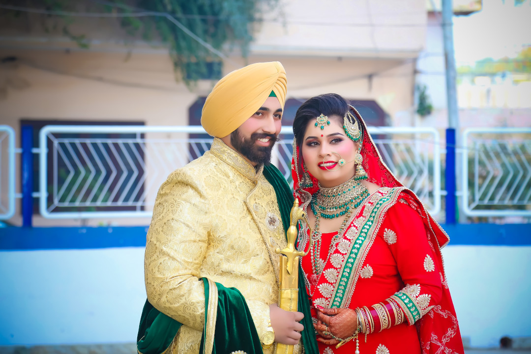 A young Sikh couple with beautiful smile posed at their Marriage